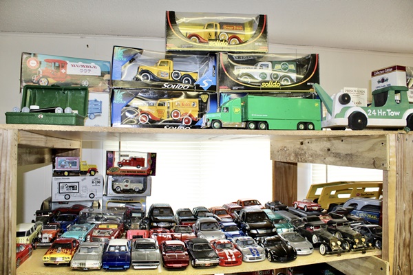 New in Box Die Cast Trucks and Shelf of Die Cast Cars